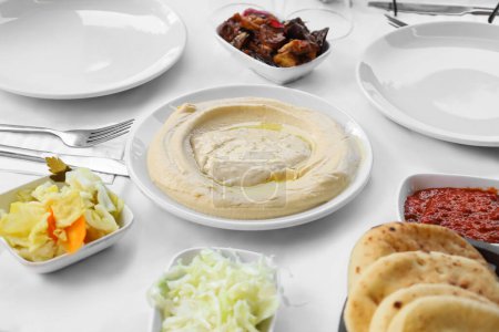 Photo for Plate with tasty hummus on table in restaurant, closeup - Royalty Free Image