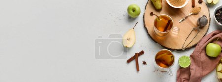 Téléchargez les photos : Tasses de thé aux fruits savoureux à la cannelle et au sucre sur fond clair avec espace pour le texte - en image libre de droit