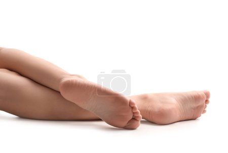 Photo for Female barefoot legs on white background - Royalty Free Image