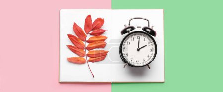 Photo for Alarm clock, notebook and autumn leaves on color background, top view - Royalty Free Image