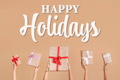 Hands with many gift boxes on beige background. Happy holidays Poster #620068450