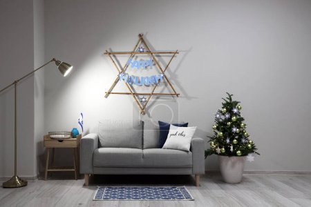 Photo for Interior of living room with sofa and fir tree decorated for Hanukkah celebration - Royalty Free Image