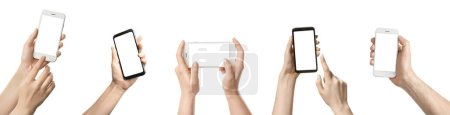 Foto de Colección de manos que sostienen teléfonos móviles con pantallas en blanco sobre fondo blanco - Imagen libre de derechos