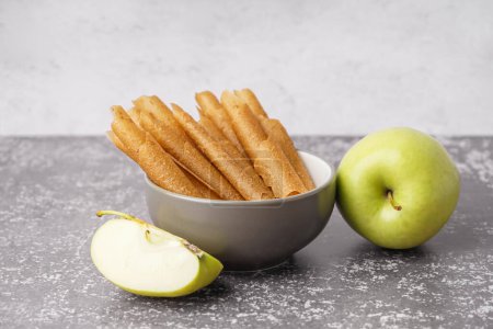Photo for Bowl of tasty apple pastilles on table - Royalty Free Image