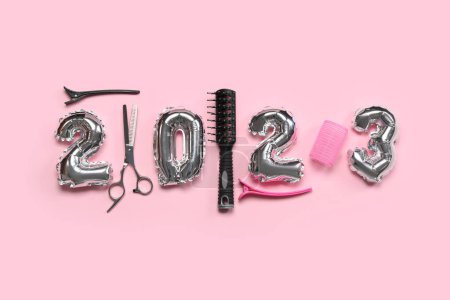 Photo for Figure 2023 made of balloons and hairdresser's tools on pink background - Royalty Free Image