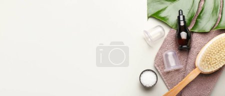 Photo for Composition with bottle of essential oil, sea salt, vacuum jars for anti-cellulite massage and brush on light background with space for text - Royalty Free Image