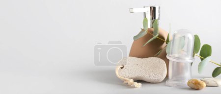 Photo for Bottle of cosmetic product, pumice and vacuum jars for anti-cellulite massage on white background with space for text - Royalty Free Image