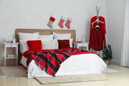 Photo for Interior of bedroom with Christmas socks and pajamas - Royalty Free Image