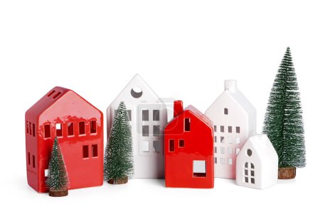 House shaped candle holders with Christmas trees on white background