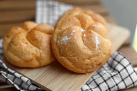 Photo for Kaiser rolls on wooden board, closeup - Royalty Free Image