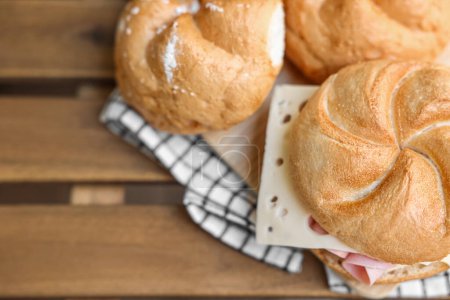 Photo for Kaiser rolls with ham and cheese on wooden board - Royalty Free Image