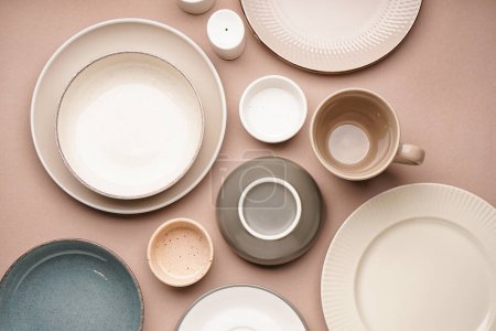 Different clean dishware on beige background