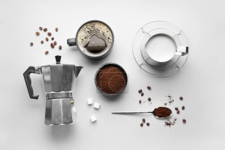 Foto de Composición con cafetera géiser, taza de espresso, leche y azúcar sobre fondo blanco - Imagen libre de derechos