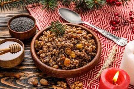 Bowl of Kutya with Christmas branch and ingredients on dark wooden background
