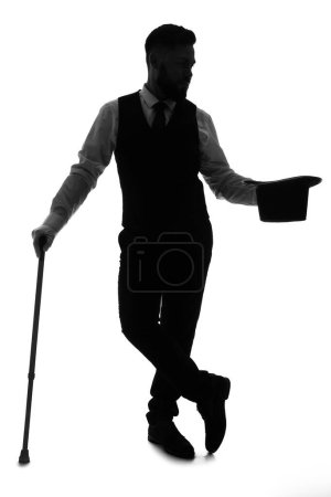 Foto de Silueta de mago macho con palo sobre fondo blanco - Imagen libre de derechos