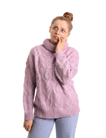 Photo for Young woman in sweater biting nails on white background - Royalty Free Image