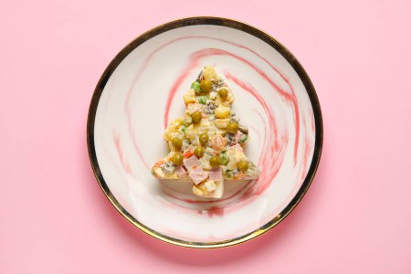 Photo for Plate with tasty Olivier salad in shape of Christmas tree on pink background - Royalty Free Image