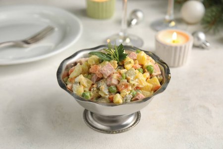Photo for Metal bowl of tasty Olivier salad on light table - Royalty Free Image