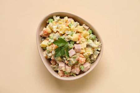 Photo for Bowl of delicious Olivier salad on color background - Royalty Free Image