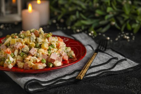 Photo for Plate of tasty Olivier salad on dark background, closeup - Royalty Free Image