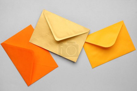 Colorful paper envelopes on light background