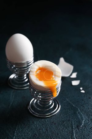 Foto de Holders with soft boiled eggs on black background - Imagen libre de derechos