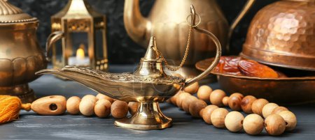 Photo for Aladdin lamp of wishes, dates and tasbih on wooden table - Royalty Free Image