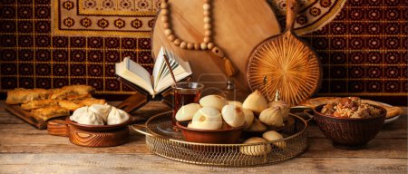 Photo for Traditional Eastern dishes with Quran on wooden table - Royalty Free Image
