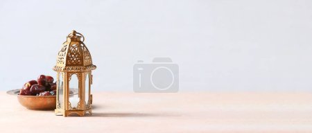 Photo for Muslim lamp and dates on light background with space for text - Royalty Free Image