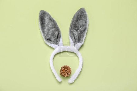 Photo for Bunny ears with fir cone on green background - Royalty Free Image