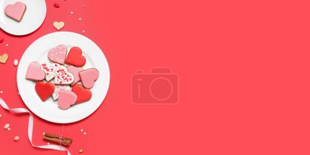 Foto de Composition with tasty heart-shaped cookies on red background with space for text. Valentine's Day celebration - Imagen libre de derechos
