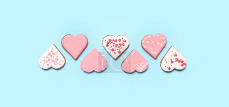 Foto de Composition with delicious heart-shaped cookies for Valentine's Day on light blue background - Imagen libre de derechos