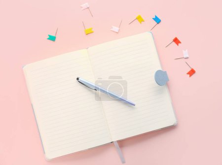 Photo for Open notebook, pen and pins on pink background - Royalty Free Image