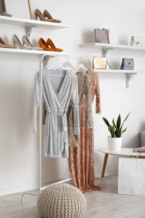 Foto de Rack with stylish female dresses in dressing room - Imagen libre de derechos