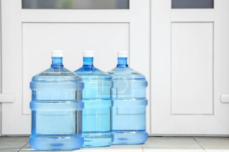Bottles of clean water on step outdoors