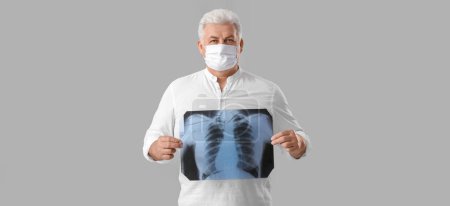 Photo for Senior man with x-ray image of lungs on grey background - Royalty Free Image