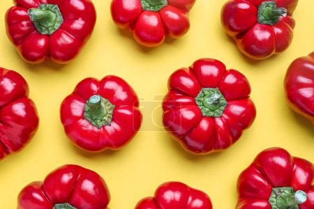 Foto de Composition with red bell peppers on yellow background - Imagen libre de derechos
