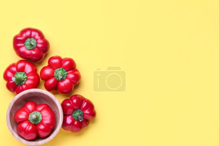 Foto de Red bell peppers on yellow background - Imagen libre de derechos