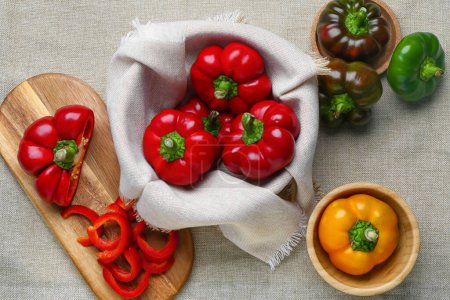 Foto de Composition with fresh bell peppers on fabric background - Imagen libre de derechos