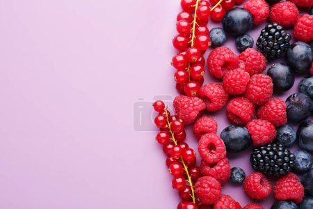 Heap of fresh ripe berries on color background