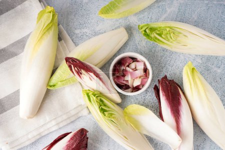 Photo for Composition with whole and cut endive on light background - Royalty Free Image