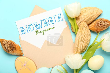 Foto de Envelope with greeting card for Novruz Bayram, flowers, eggs and sweets on light blue background - Imagen libre de derechos