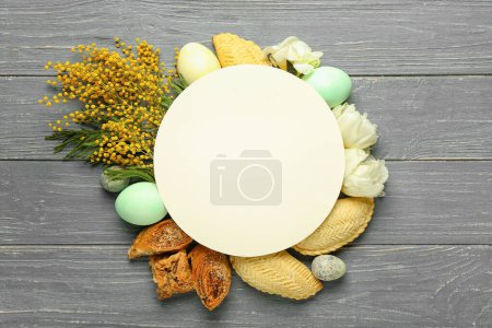 Blank card with flowers, eggs and treats on dark wooden background. Novruz Bayram celebration