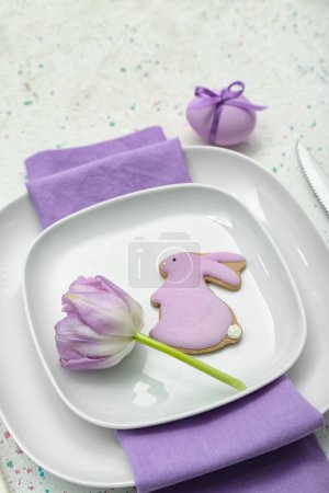 Photo for Table setting with Easter egg, bunny and tulip flower on white background - Royalty Free Image