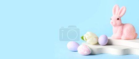 Téléchargez les photos : Empty podiums with Easter eggs, bunny and tulip flower on blue background with space for text - en image libre de droit