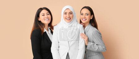 Foto de Beautiful businesswomen on beige background. Unity concept - Imagen libre de derechos