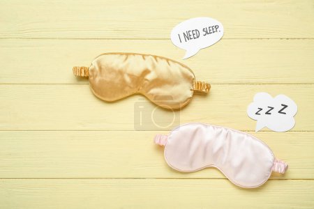 Photo for Sleeping masks and speech bubbles on color wooden background. World Sleep Day concept - Royalty Free Image