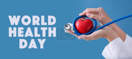 Photo for Hands of cardiologist with stethoscope and red heart on blue background. World Health Day - Royalty Free Image