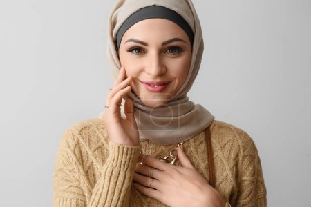 Photo for Stylish Muslim woman in beige hijab on light background, closeup - Royalty Free Image