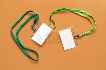 Photo for Blank badges with green lanyards on color background - Royalty Free Image